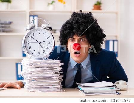 Young clown businessman working in the office Young clown businessman working in the office 105011522