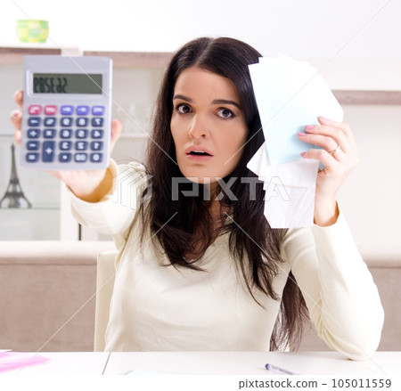 Young woman with receipts in budget planning concept Young woman with receipts in budget planning concept 105011559