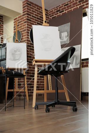 Art classroom interior with easels and drawing tools, nobody. Sketching classes and workshops in fine art for adults, sketch artworks in empty artist studio. Hobby to develop creativity Art classroom interior with easels and drawing tools, nobody. Sketching classes and workshops in fine art for adults, sketch artworks in empty artist studio. Hobby to develop creativity 105011829