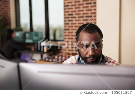Software developer typing javascript code on computer to develop online cloud computing information. African american tech enginner writing html script and data algorithm, working in it office 105011897