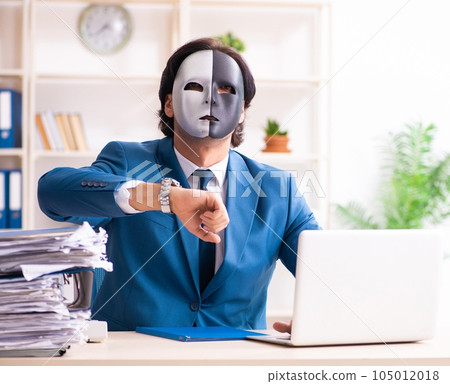 Male employee in the office in industrial espionage concept 105012018