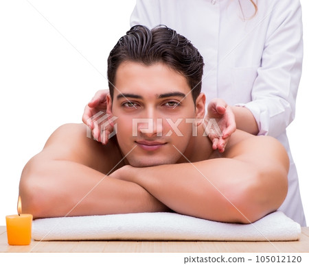 Handsome man during spa massaging session 105012120