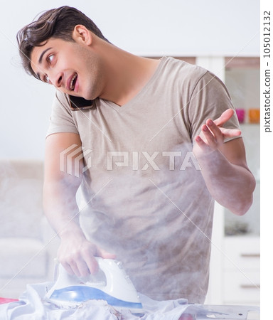 Inattentive husband burning clothing while ironing 105012132