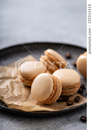 Coffee or chocolate macarons on a tray 105012418