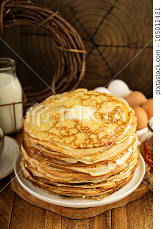 Stack of thin russian pancakes or crepes 105012481