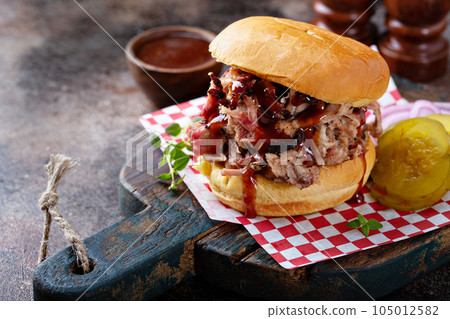Pulled pork sandwich with pickles Pulled pork sandwich with pickles 105012582