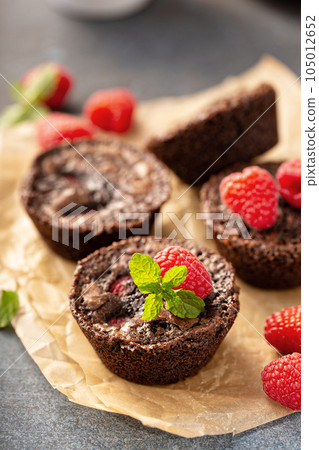 Homemade brownie bites with raspberries 105012652
