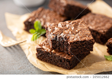 Freshly baked brownies on a parchment paper Freshly baked brownies on a parchment paper 105012662