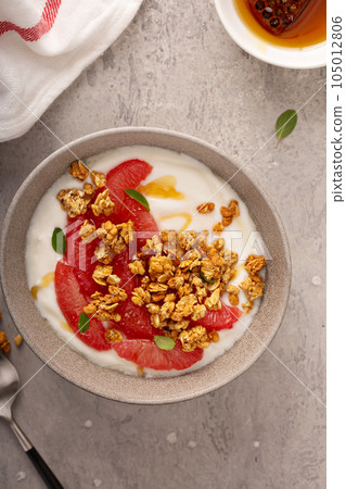 Yougurt bowl with grapefruit slices and granola Yougurt bowl with grapefruit slices and granola 105012806