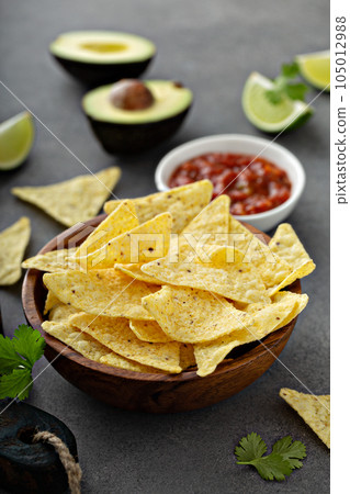 Tortilla chips in a bowl with salsa Tortilla chips in a bowl with salsa 105012988