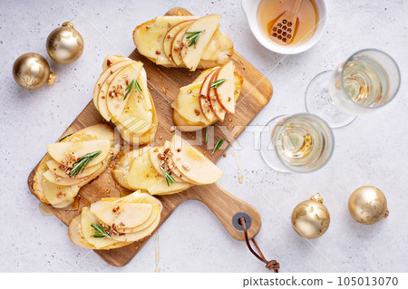 New Years Eve party appetizer, pear and brie crostini 105013070
