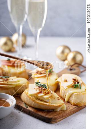 New Years Eve party appetizer, pear and brie crostini 105013078