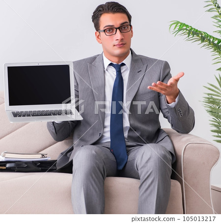 Businessman with laptop notebook sitting in sofa Businessman with laptop notebook sitting in sofa 105013217