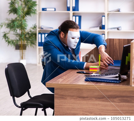 Young male employee wearing mask in the office Young male employee wearing mask in the office 105013271