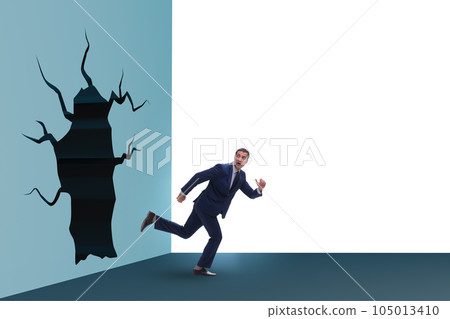 Businessman breaking through the wall Businessman breaking through the wall 105013410