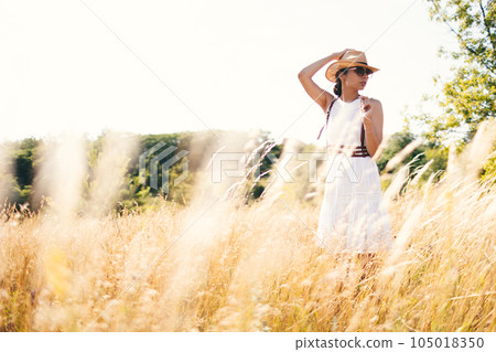 Beautiful girl in a linen dress in a wheat field. Beautiful girl in a linen dress in a wheat field. 105018350
