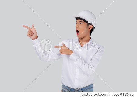 Portrait young asian man is engineer wearing helmet standing and excited. Portrait young asian man is engineer wearing helmet standing and excited. 105018556