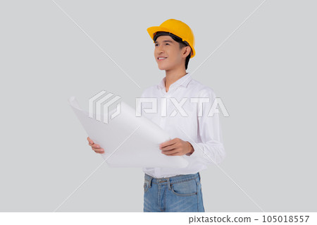 Portrait young asian man is engineer wearing helmet holding and looking blueprint with confident. Portrait young asian man is engineer wearing helmet holding and looking blueprint with confident. 105018557