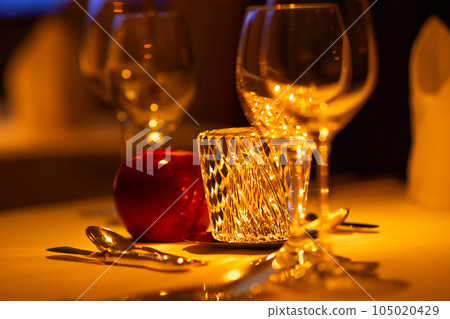 Beautiful table lit by candles Beautiful table lit by candles 105020429
