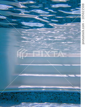 Underwater view of white swimming pool steps with clean rippling water Underwater view of white swimming pool steps with clean rippling water 105021508