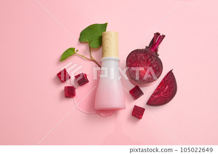 Mockup scene for advertising and branding cosmetic with beetroot ingredient. Pink bottle unbranded on pink background with beet slices and fish mint. Concept for cosmetic with natural extract 105022649
