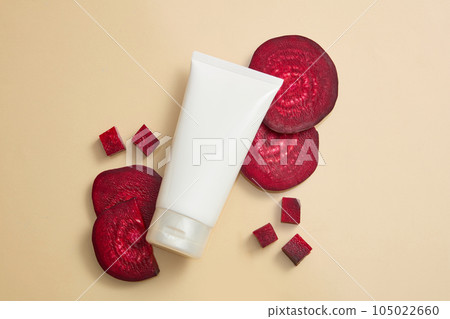 Background for the presentation of cosmetic products with empty plastic bottle with beetroot slices decorated on beige paper. Beetroots are a good source of nutrients, fiber, and many plant compounds 105022660