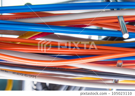 Detail of server room with bunch of fiber optic cables Detail of server room with bunch of fiber optic cables 105023110