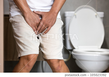 Asian middle aged man suffering from dysuria,acute cystitis, urinary tract infection,people patient holding crotch in toilet,prostate problems,inflammation of urethra,painful or difficult urination 105023392