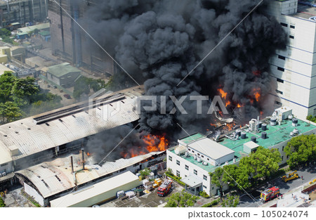 Aerial view of Fire in industrial building. 105024074