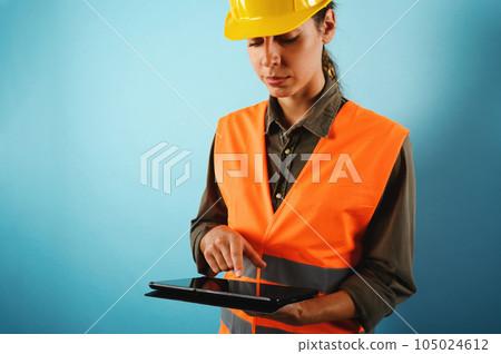 Woman with helmet who work in a warehouse Woman with helmet who work in a warehouse 105024612