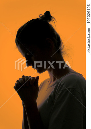 Profile Of A Woman Praying In Silhouette Isolated in Studio Profile Of A Woman Praying In Silhouette Isolated in Studio 105026198