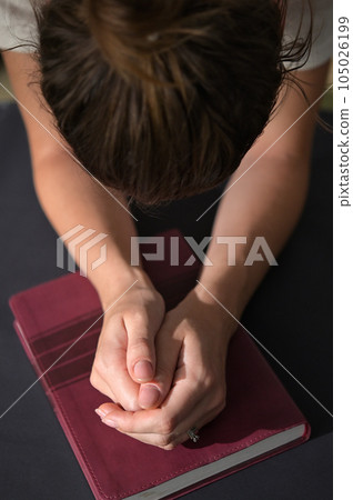 Christian Woman Hands Folded On Holy Bible Are Pray And Worship Christian Woman Hands Folded On Holy Bible Are Pray And Worship 105026199
