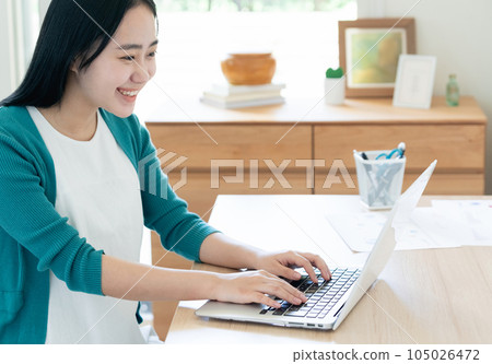 A young woman working on a computer 105026472