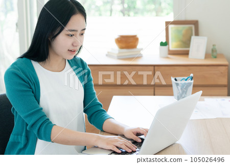 A young woman working on a computer 105026496