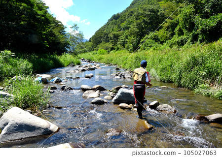 An angler fishing with a lure in a beautiful valley An angler fishing with a lure in a beautiful valley 105027063