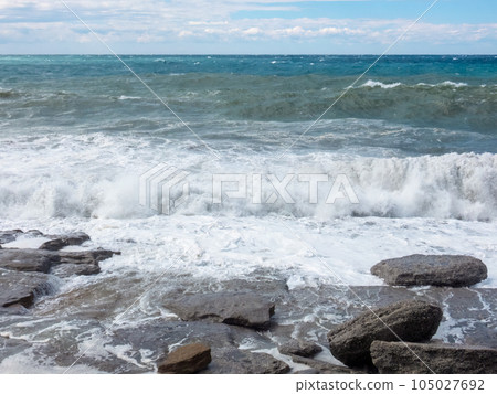 The Mediterranean Sea powerful waves crashing over the rocks in stormy weather. The Mediterranean Sea powerful waves crashing over the rocks in stormy weather. 105027692