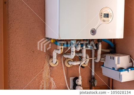 Rusty pipe on a gas boiler close-up. 105028134