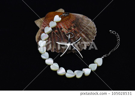 Women's jewelry in the form of natural pearl beads on a black background Women's jewelry in the form of natural pearl beads on a black background 105028531