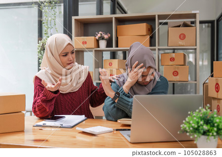Stressed two friend muslim female work online business feeling upset and unhappy about the online product sales Stressed two friend muslim female work online business feeling upset and unhappy about the online product sales 105028863