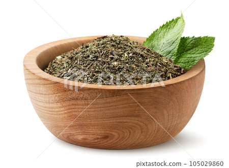 Dried mint in a wooden plate with leaves on a white background. Isolated Dried mint in a wooden plate with leaves on a white background. Isolated 105029860