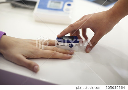 Pregnant woman with pulse oximeter on finger Pregnant woman with pulse oximeter on finger 105030664
