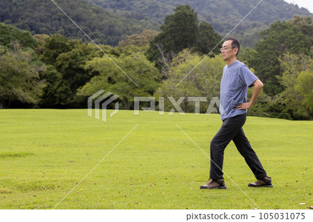 Mature man exercising on the lawn Mature man exercising on the lawn 105031075