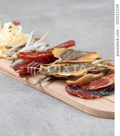 Dried fish, beer snack close-up on a wooden board. Dried fish, beer snack close-up on a wooden board. 105031159