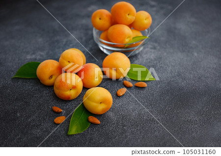 Delicious ripe apricots on black background, close-up. Delicious ripe apricots on black background, close-up. 105031160