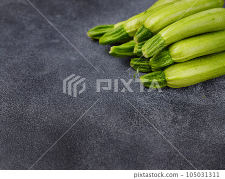 Fresh zucchini, green vegetables on local farmer market Fresh zucchini, green vegetables on local farmer market 105031311