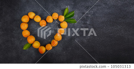 Delicious ripe apricots on black background, close-up. Delicious ripe apricots on black background, close-up. 105031313