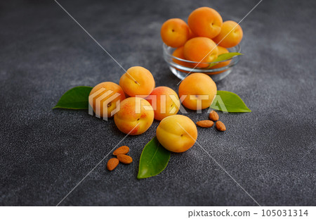 Delicious ripe apricots on black background, close-up. Delicious ripe apricots on black background, close-up. 105031314