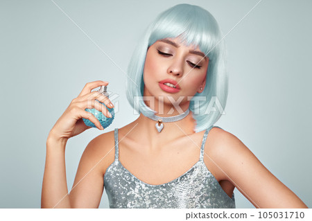 Beautiful glamorous girl with a perfume bottle 105031710