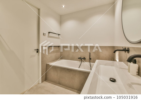 a modern bathroom with white walls and beige tiles on the floor, there is a large mirror above the sink 105031916