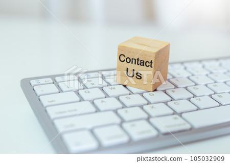Concept of contact us. wooden cube blocks with contact us on computer keyboard. Concept of contact us. wooden cube blocks with contact us on computer keyboard. 105032909